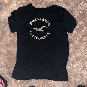 A black hollister shirt fitted comfortable with gold lettering on it